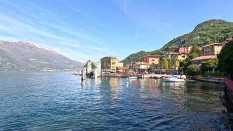 beautiful lakeside town with mountains and boats