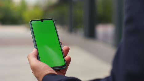 businessman swiping template mobile phone. closeup hands touching chroma key