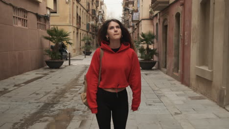 young girl dreamly walking in the street