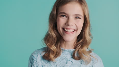 teenage caucasian girl nodding with thumbs up looking at the camera.