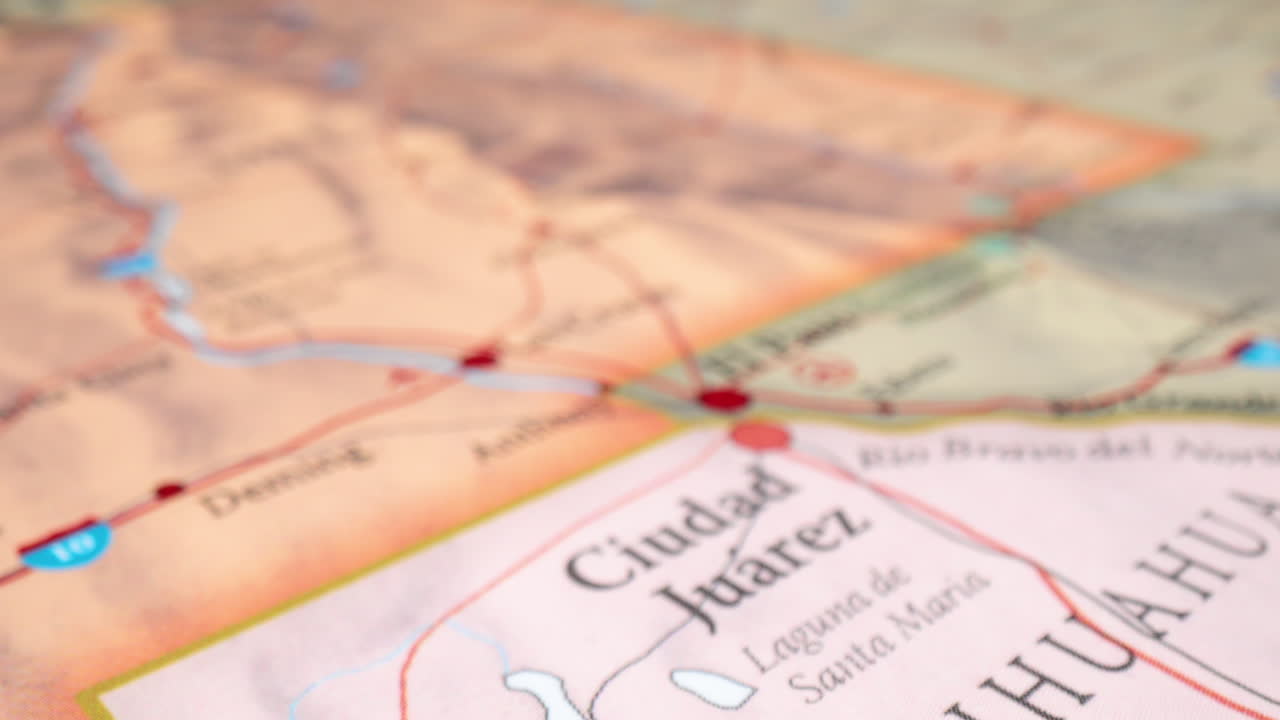 Closeup Of Map Highlighting Border Crossing Between Ciudad Juarez, Mexico, And El Paso, USA. zoom-in shot, rack focus