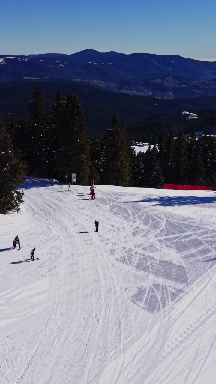 Skiers enjoy winter sports in the Carpathians region of Bulgaria