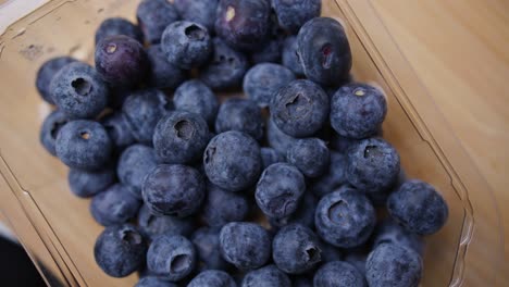 a full close up of a punnet of fresh blueberries