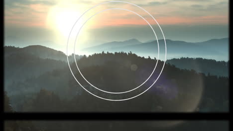 animation of circular scope and slipping frame over idyllic misty mountain landscape at sunset