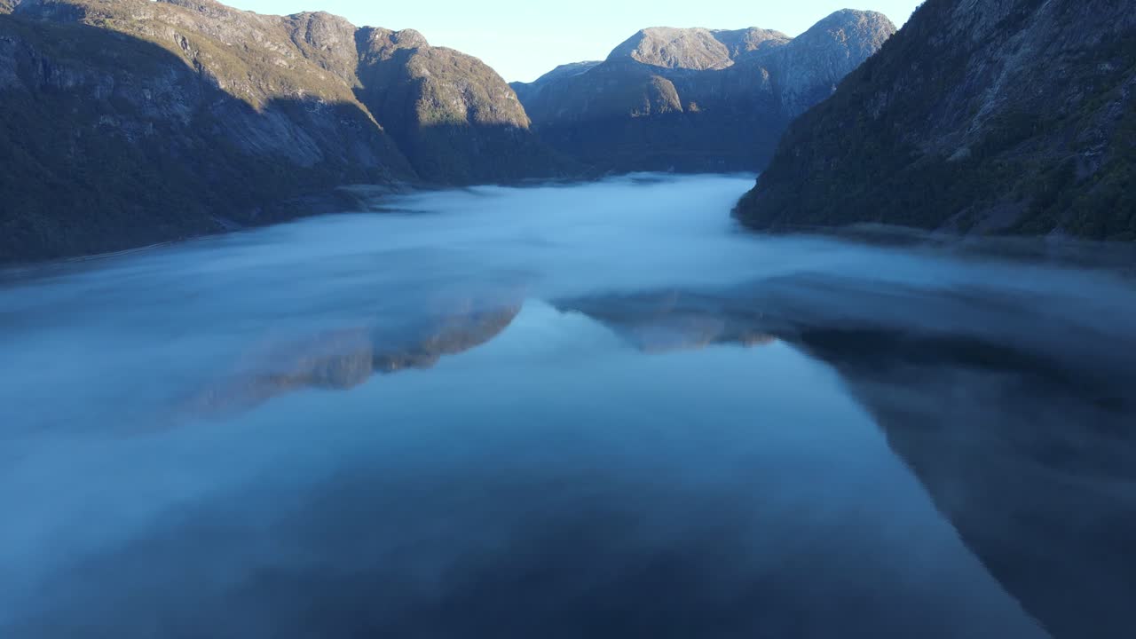 A mist over beautiful fjord of Hardanger in Western Norway. Early morning drone footage