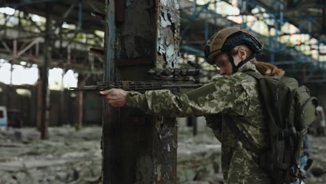 female soldier with rifle in a war zone