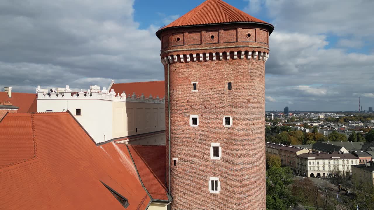 Majestic tower of Wawel royal medieval castle in Krakow - historical tourists attraction in Poland, during sunny day - drone 4K