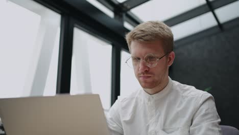 customer service department in it-company, adult man is typing message in online chat for answer