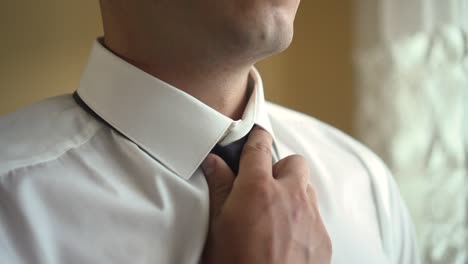 a man puts on a tie 02