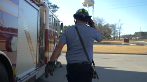 firefighter walking away from firetruck