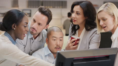 Creative-business-team-meeting-happy-people-working-in-modern-office-late-at-night-discussing-strategy-using-computer-touch-screen-in-diverse-gender-group