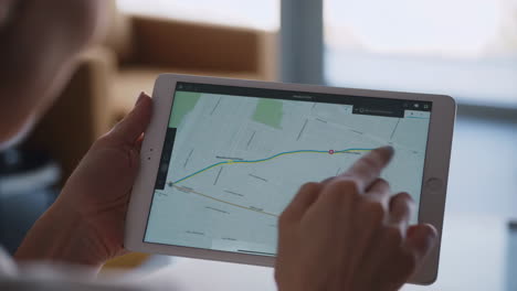 person using a tablet to navigate a map