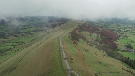 hiking groups walking along mam tor ridge, peak district