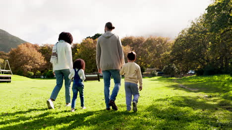 Back,-walking-and-an-interracial-family-at-a-park