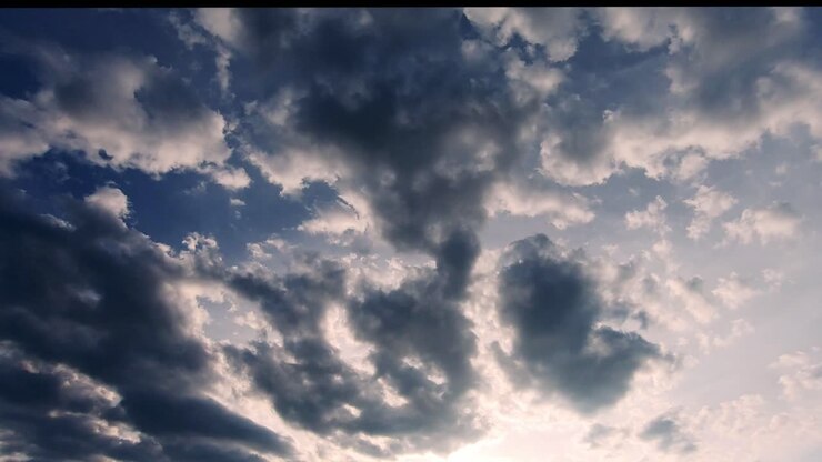 Dark clouds moving at sunset. Static, low angle