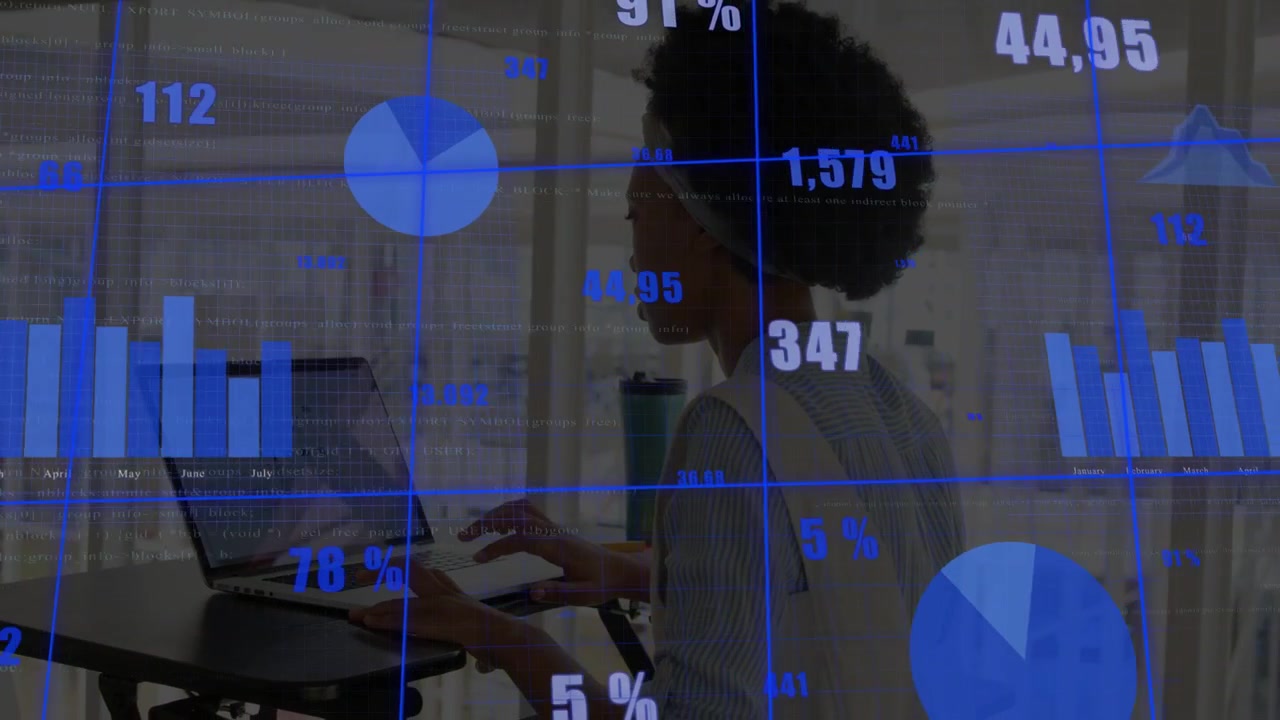 Woman typing at stand desk near windows, analyzing data with animated charts sweeping across view