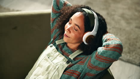 woman relaxing on couch with headphones