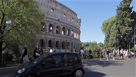 tourists walking near the colosseum in rome, italy slow motion