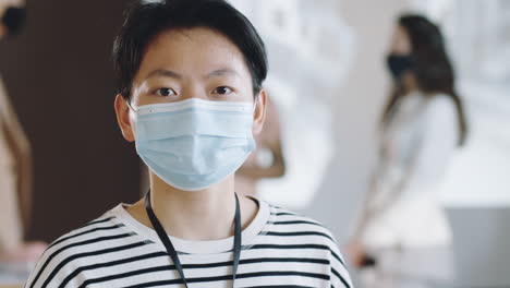 portrait of asian woman in mask on business conference