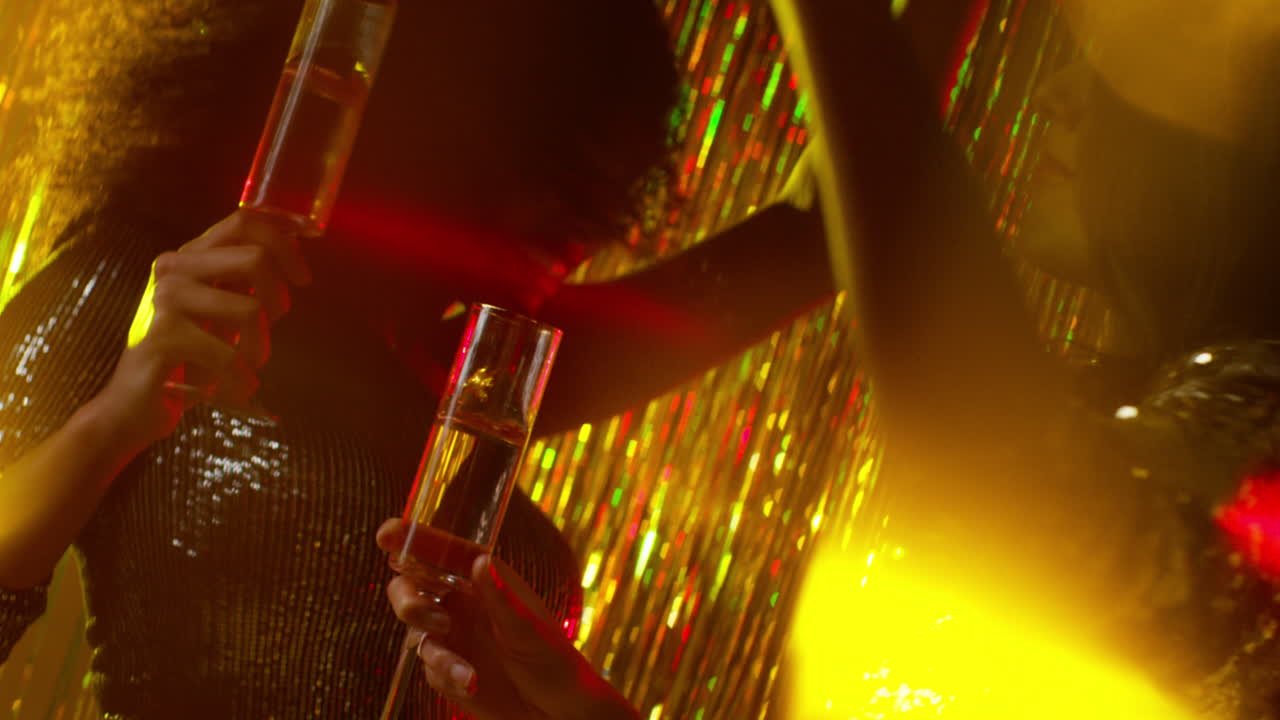 Close Up Of Two Women Dancing In Nightclub Bar Or Disco Drinking Alcohol With Sparkling Lights 17