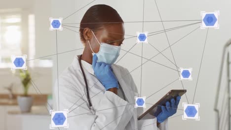 Animation-of-connections-over-female-african-american-doctor-wearing-face-mask-using-tablet