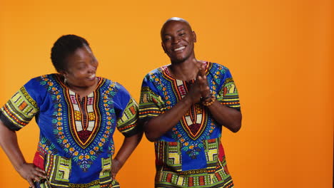 joyful man and woman laughing together in studio