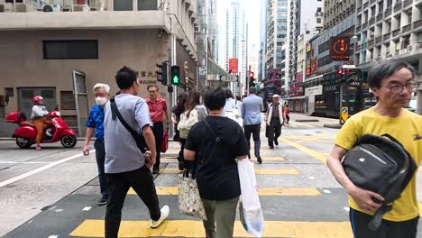 people walking and crossing at a city intersection