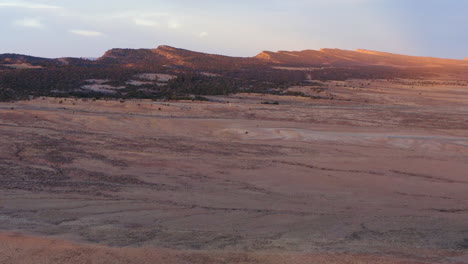 Aerial-view-of-a-endless-desert,-sunny-day,-in-USA---tilt,-drone-shot