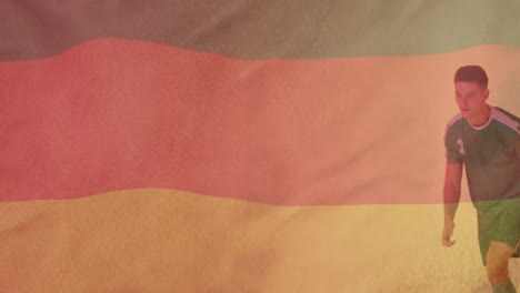 animation of flag of germany over caucasian male football player kicking ball