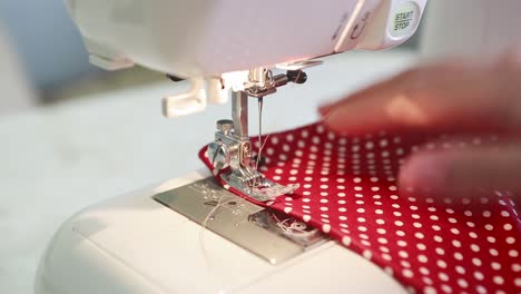 woman working on sewing machine. close up of woman adjusting her sewing machine in the process of making clothes