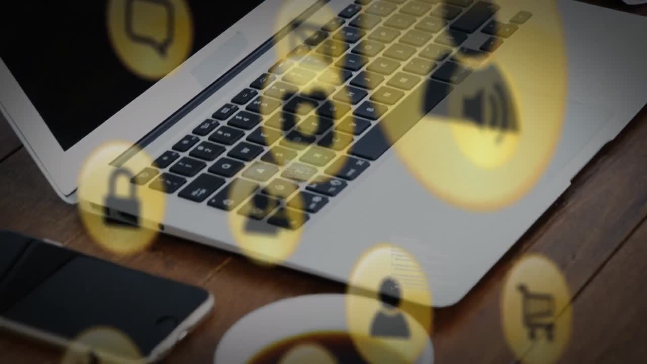 Animation of online digital icons over smartphone and laptop