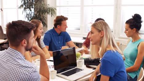 male and female business executives interacting with each other in a meeting