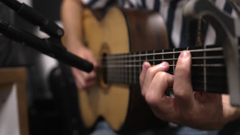 close-up of hands strumming chords on an acoustic guitar in a music studio in rio, brazil, performing with skill and rhythm in recording studio