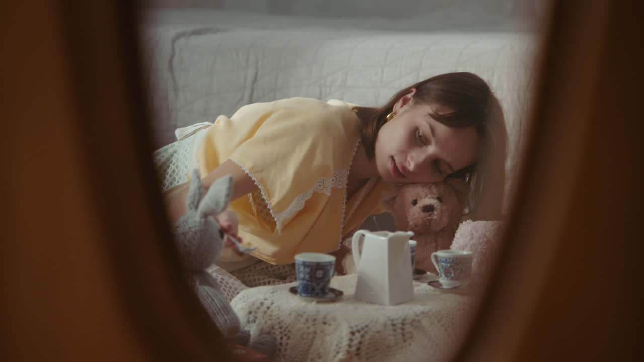 A girl playing with dolls in her room