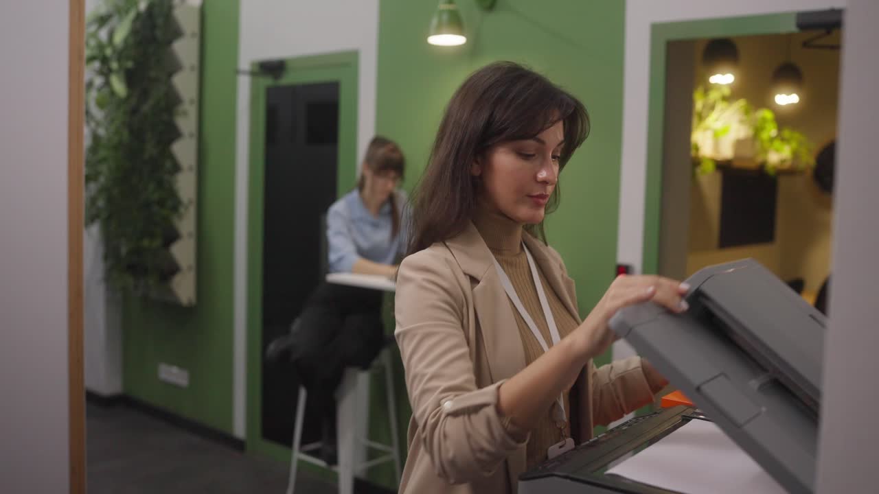 Woman using a printer in an office