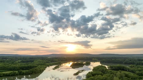 Clouds-drift-toward-sunset-at-wetlands-around-Lake-Sequoyah,-Arkansas,-USA---Hyperlapse-Aerial