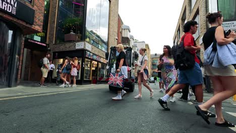 crowds walking in a bustling london street