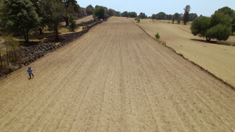 Aerial-Footage-of-a-farmer-preparing-the-land-for-the-crops