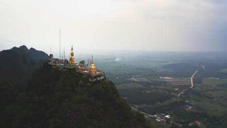 templo budista de la cueva del tigre en la cima de la montaña sobre el campo de tailandia