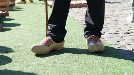 dutch man's feet in wooden clogs at the gouda cheese market in the netherlands