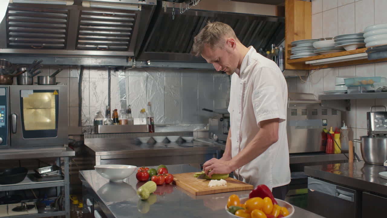 Chef Slicing Zucchini At Restaurant Kitchen
