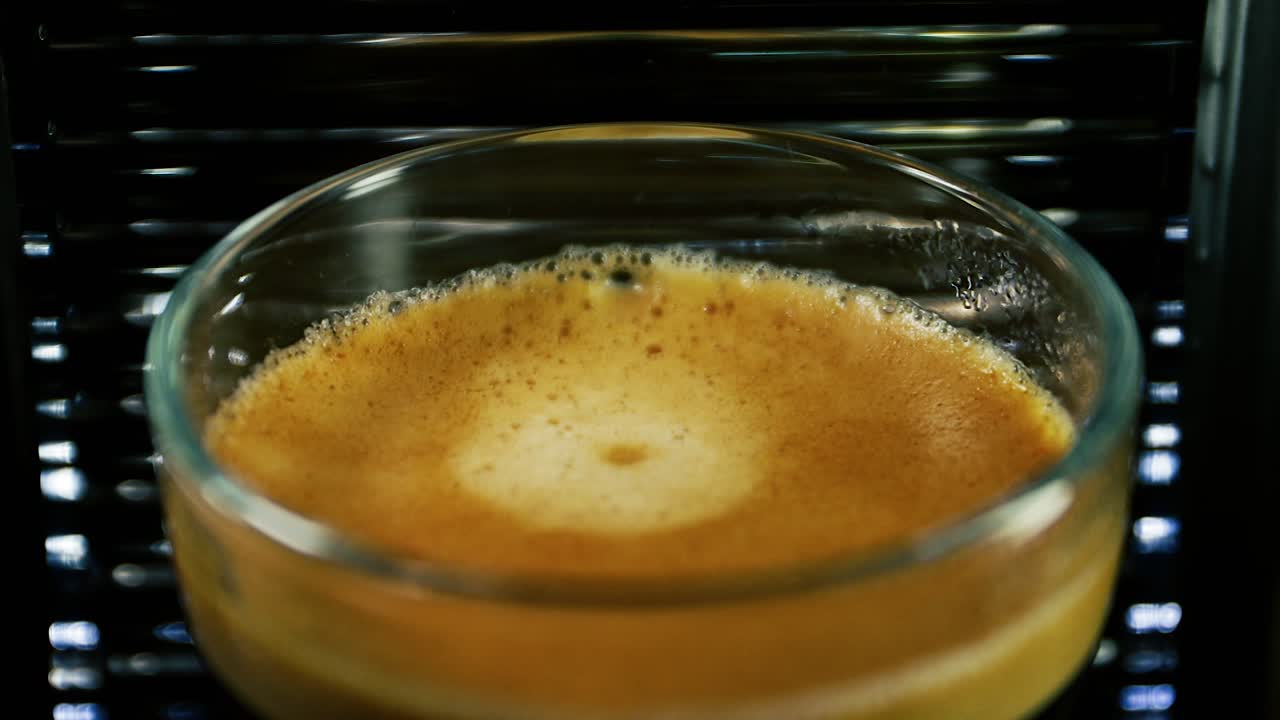 Closeup View Of A Coffee Drop Dripping On The Glass Of Frothy Espresso - Slowmo