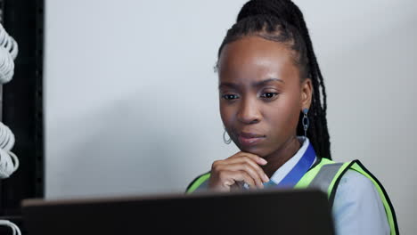 Solution,-laptop-and-black-woman-in-server-room