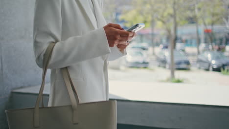 unknown woman using smartphone walking to office work closeup. lady typing phone