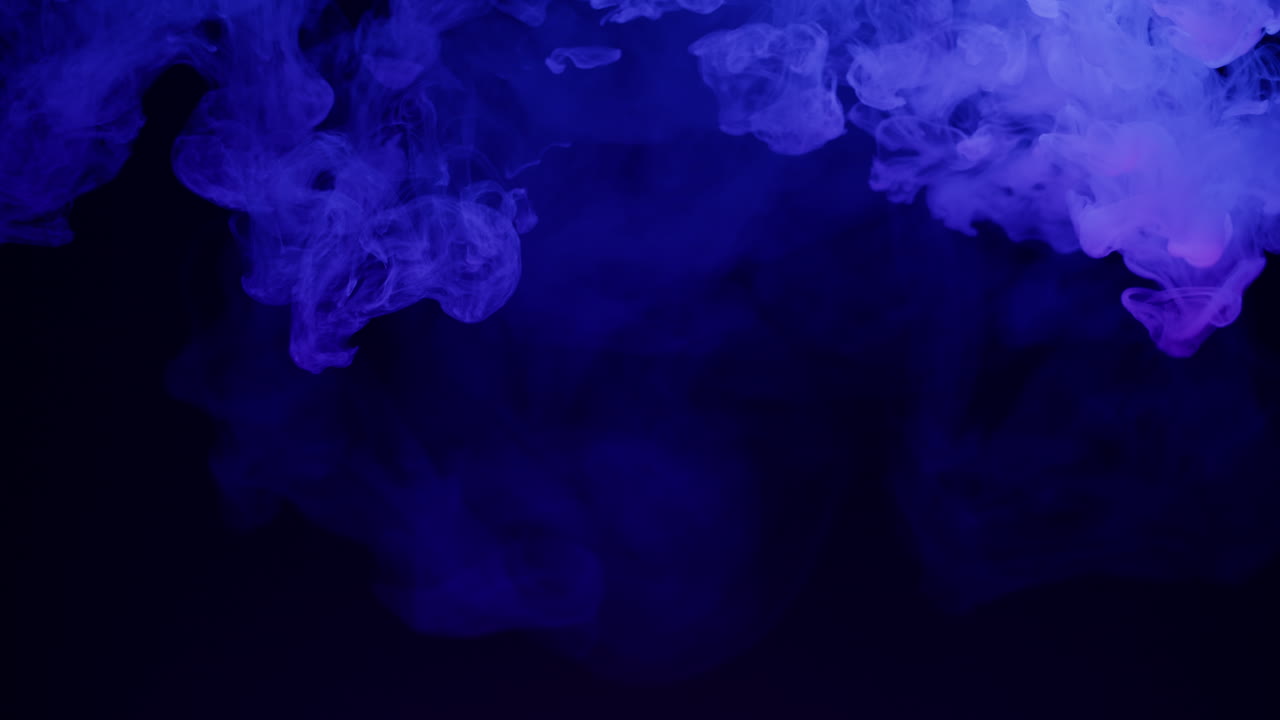 Abstract Purple and Blue Smoke Swirling on Dark Background