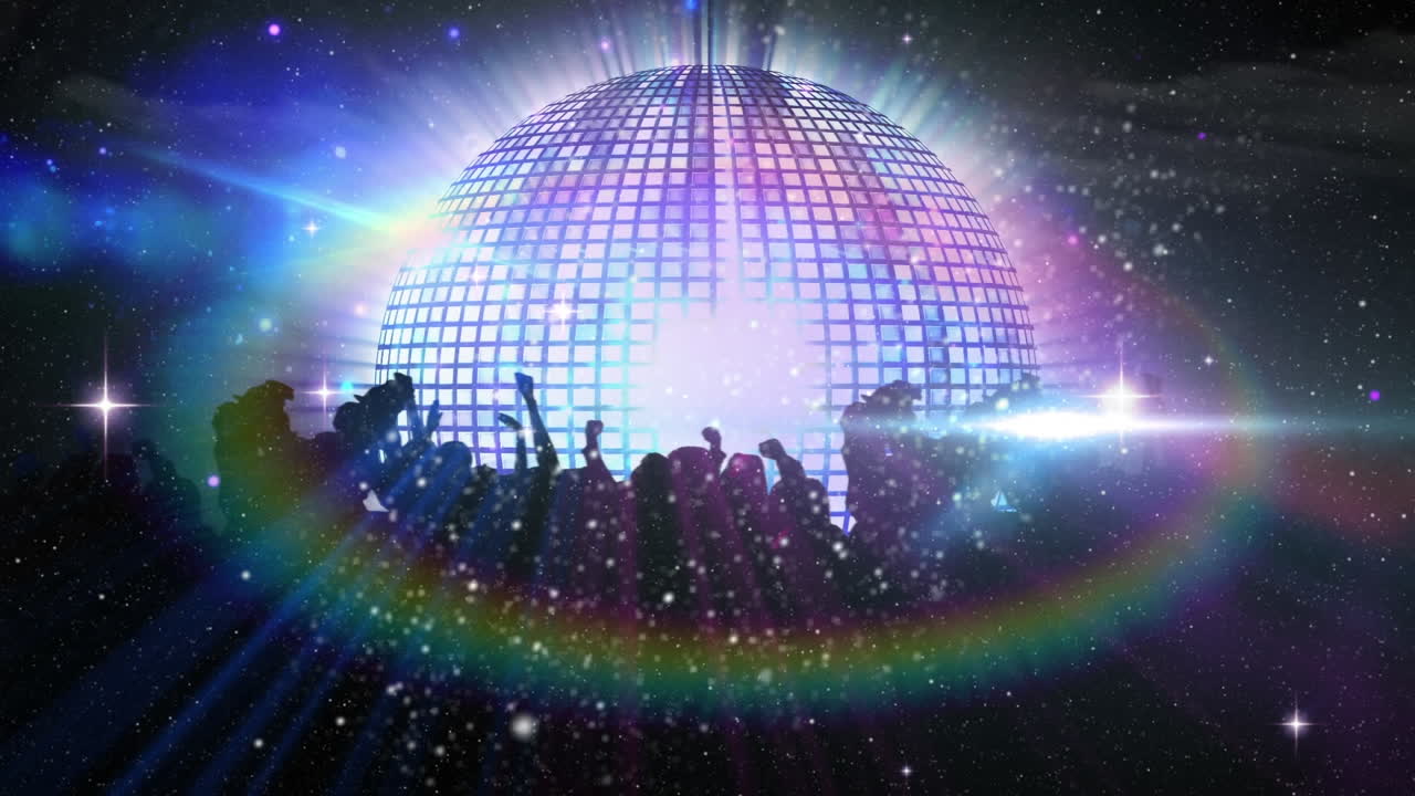 People dancing at music concert against mirror disco ball spinning