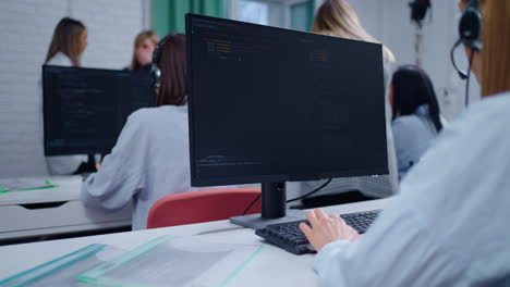 women coding in a office setting