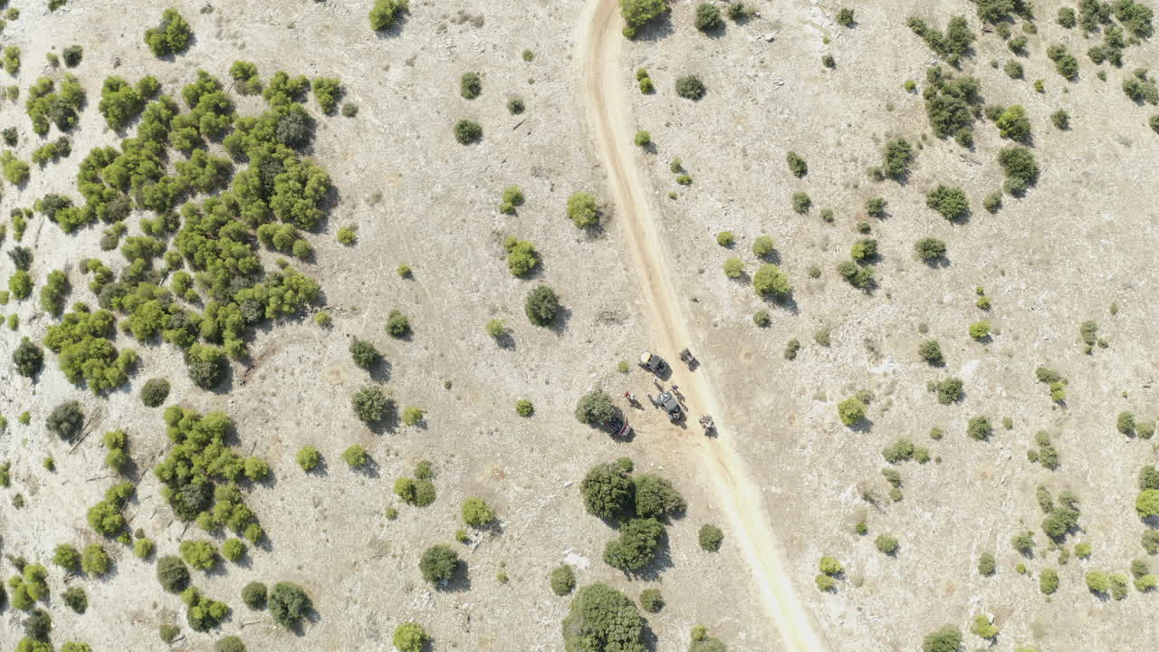Group of Explorers with Dune Buggies Parked Up on Dusty Desert Path Road, Aerial Top View