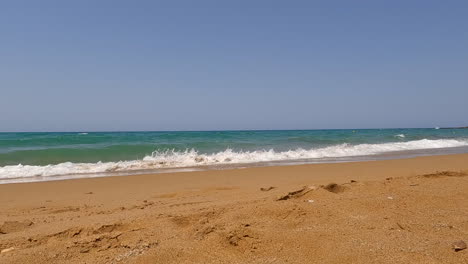 the turquoise sea spills onto the beach of crete