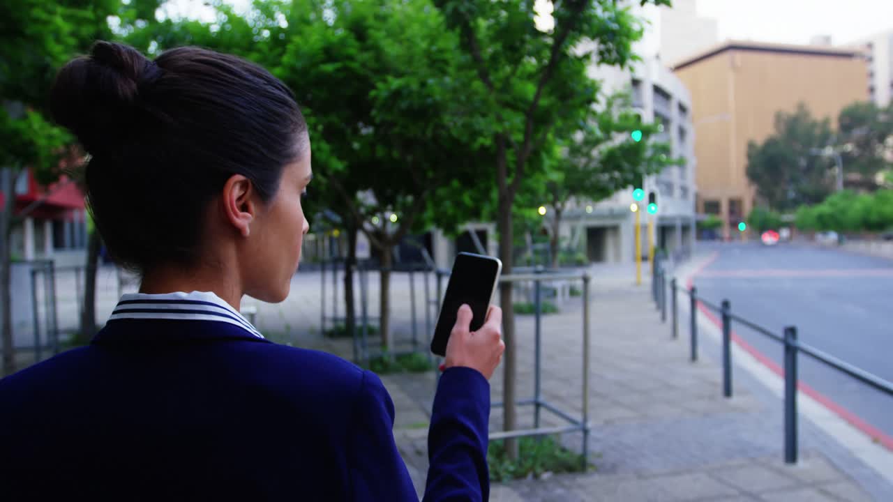 Businesswoman text messaging on mobile phone